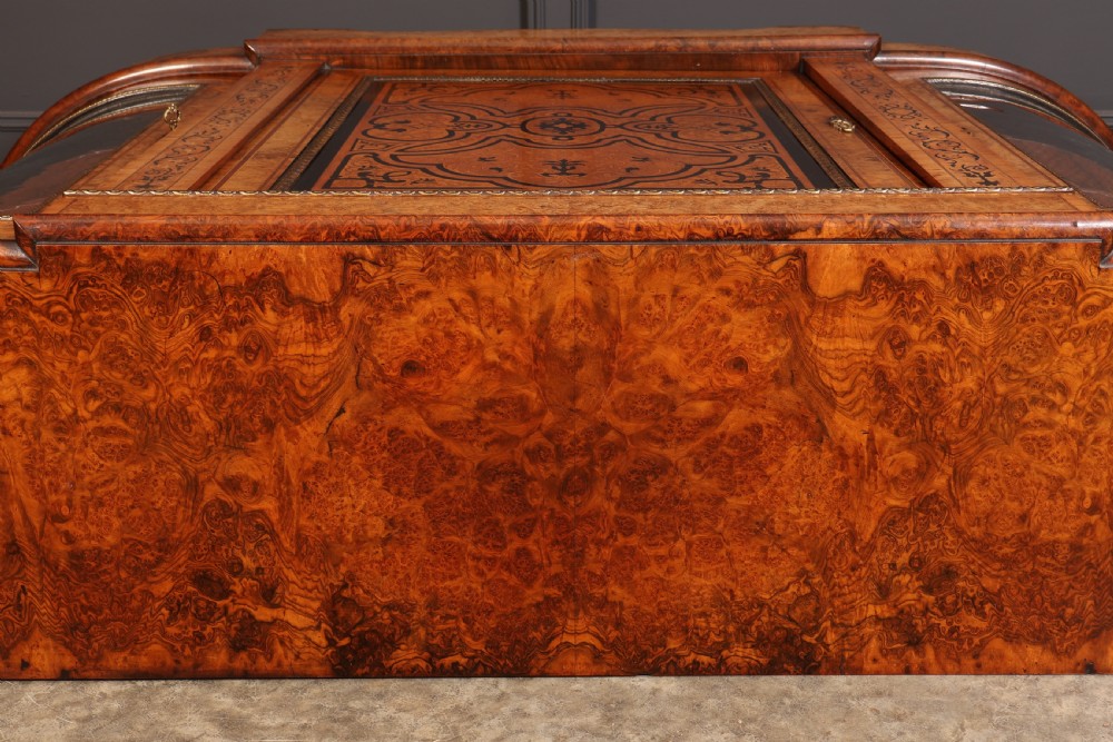 A nineteenth-century Victorian credenza made from burr walnut featuring central floral marquetry, curved glazed side display doors, and polished metal mounts. View X