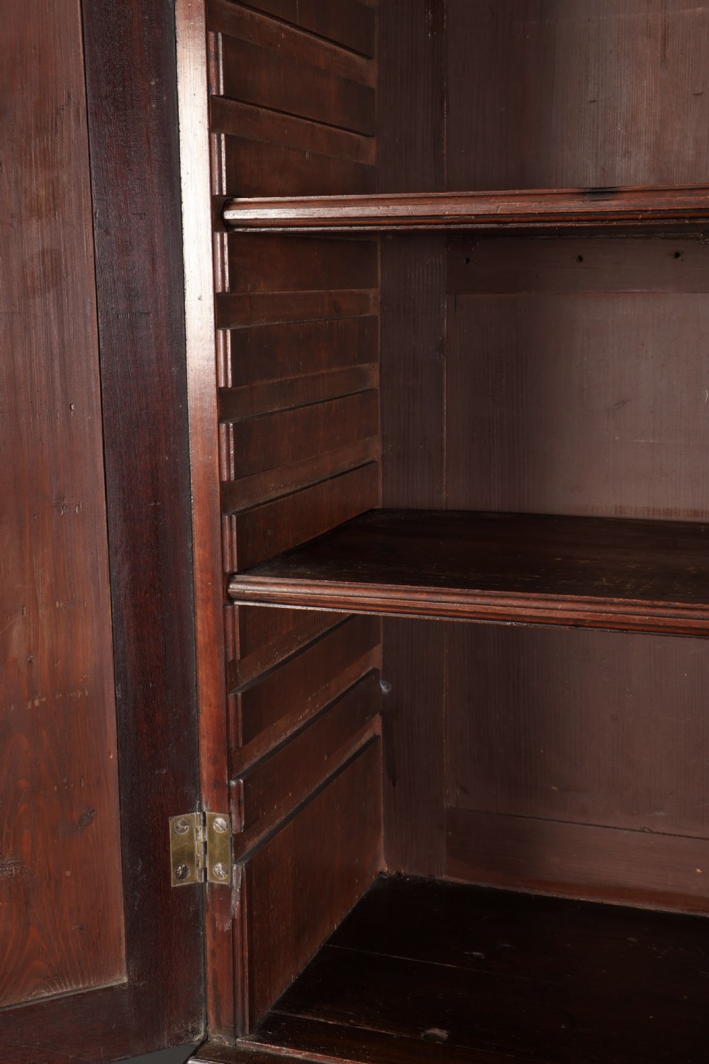 A Georgian rich mahogany bureau bookcase featuring a two-door upper cabinet, slant-front writing bureau, four drawers with brass handles, and bracket feet. View V