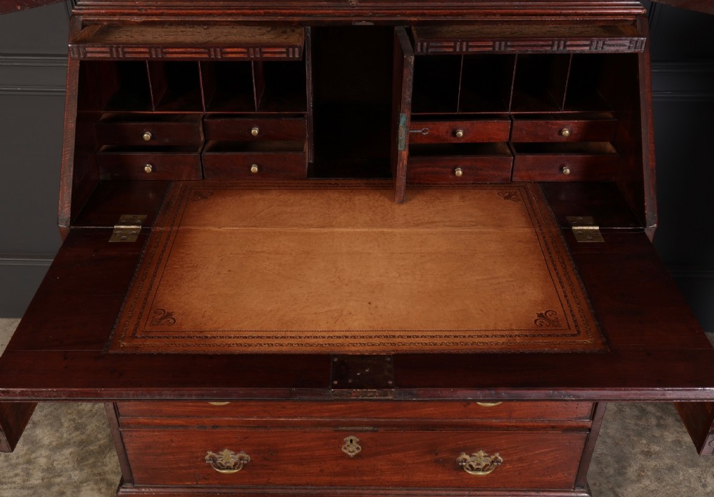 A Georgian rich mahogany bureau bookcase featuring a two-door upper cabinet, slant-front writing bureau, four drawers with brass handles, and bracket feet. View VIII