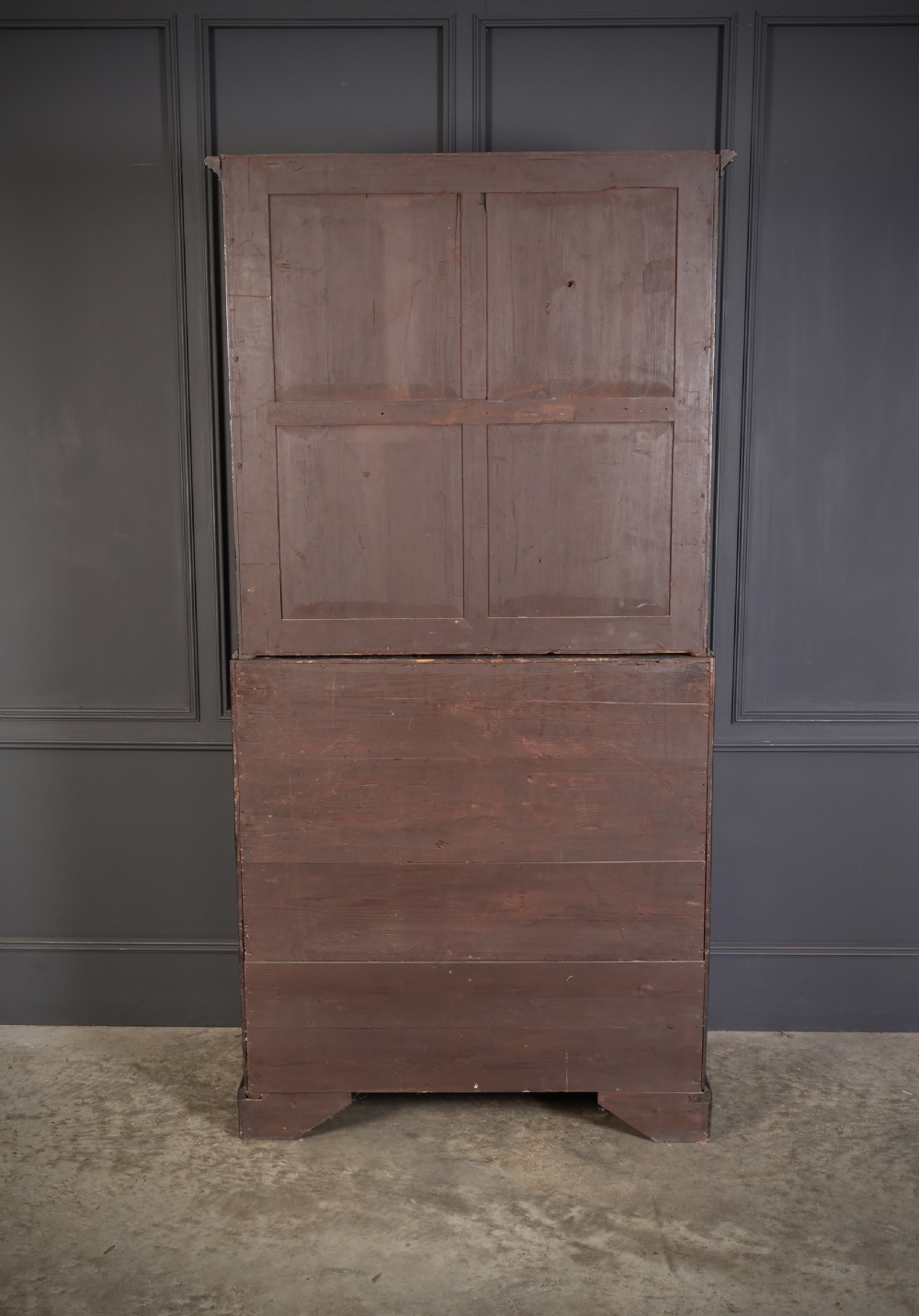 A Georgian rich mahogany bureau bookcase featuring a two-door upper cabinet, slant-front writing bureau, four drawers with brass handles, and bracket feet. View XII