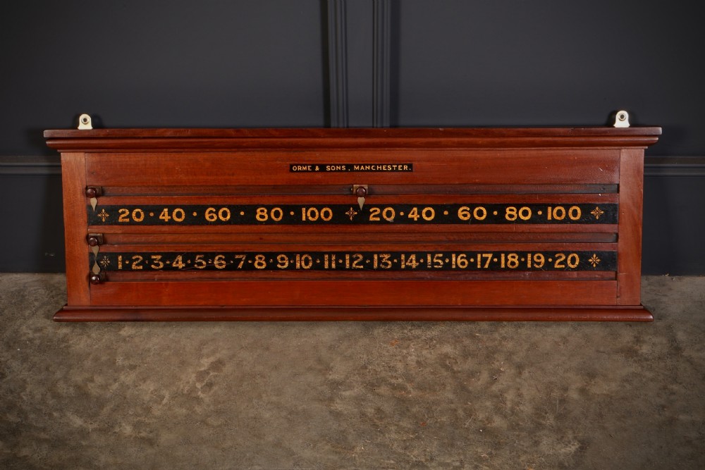 A wall-mounted Victorian mahogany snooker scoreboard featuring brass sliding pointers and gilded numerals set against black painted tracks.