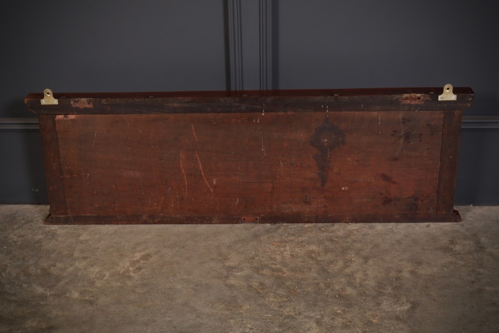 A wall-mounted Victorian mahogany snooker scoreboard featuring brass sliding pointers and gilded numerals set against black painted tracks. View V
