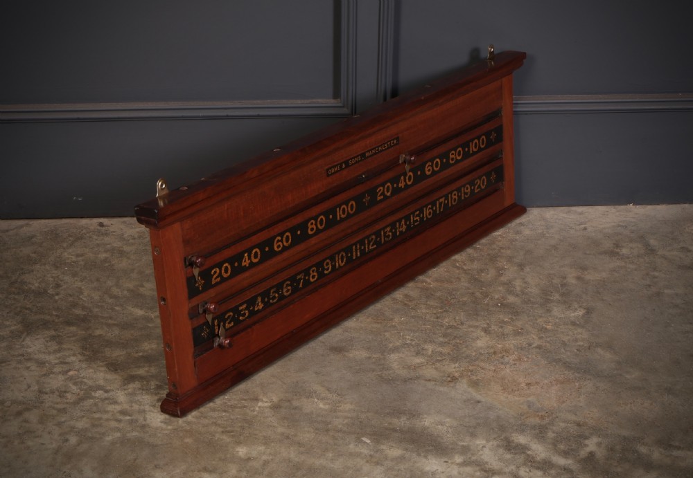 A wall-mounted Victorian mahogany snooker scoreboard featuring brass sliding pointers and gilded numerals set against black painted tracks. View VI