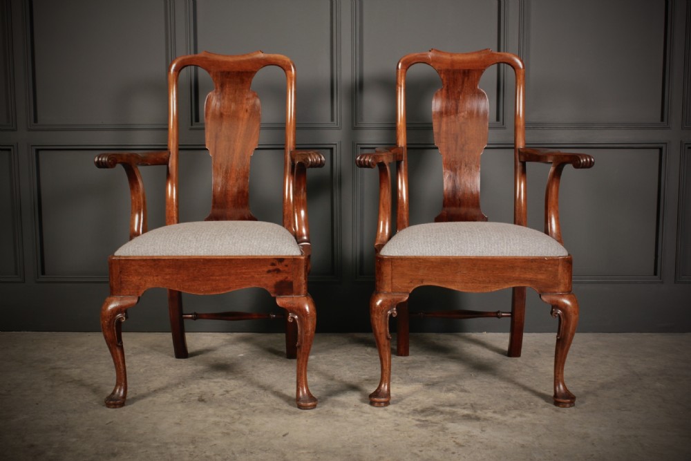 A pair of polished mahogany Queen Anne armchairs featuring vasiform back splats, outcurved armrests, cabriole front legs with pad feet, and light neutral upholstered seats. View II