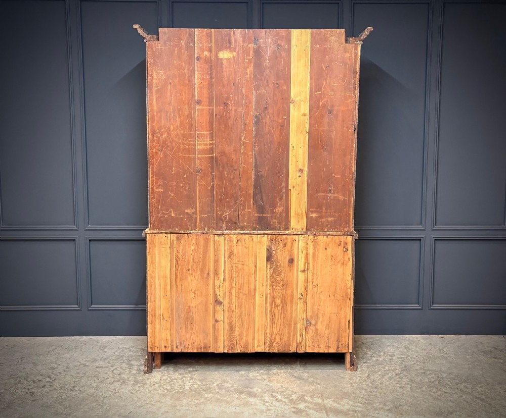 A large two-tier bleached oak open bookcase featuring heavily carved floral pilasters, open adjustable shelves, and a lower cabinet with relief-carved doors. View IX