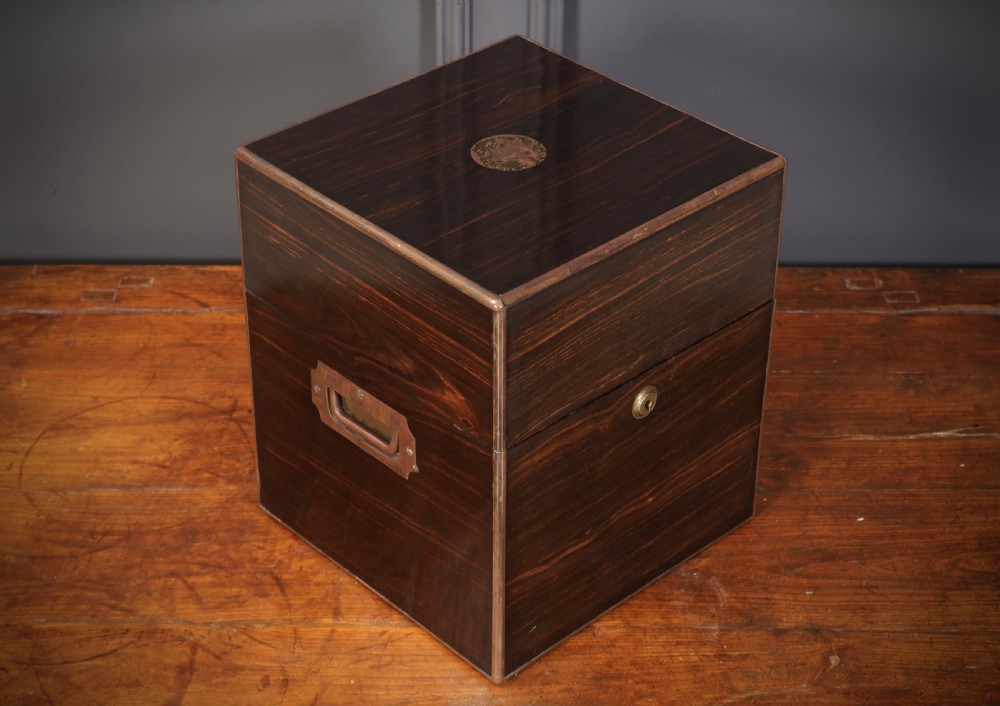 A Victorian coromandel wood decanter box lined with purple velvet, containing four square cut-glass decanters with faceted square stoppers. View III