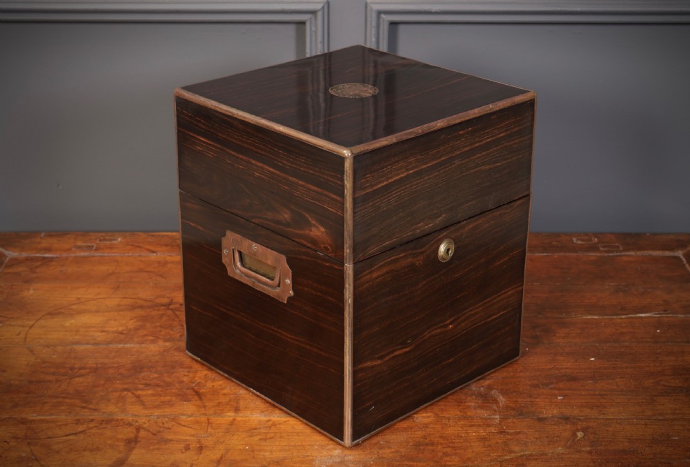 A Victorian coromandel wood decanter box lined with purple velvet, containing four square cut-glass decanters with faceted square stoppers. View II