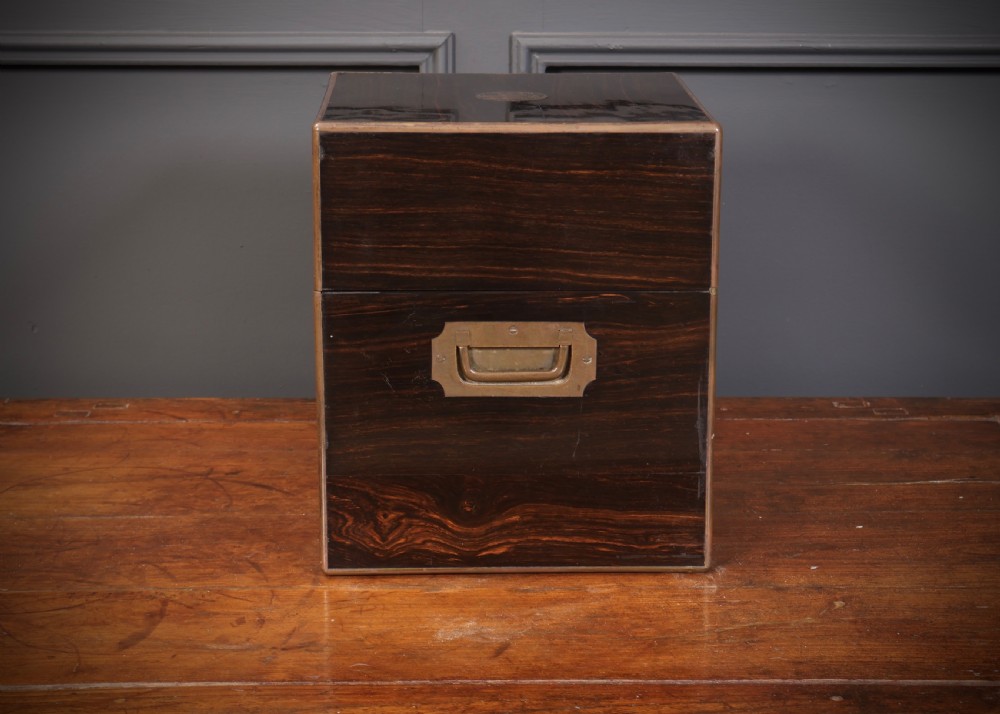 A Victorian coromandel wood decanter box lined with purple velvet, containing four square cut-glass decanters with faceted square stoppers. View IX