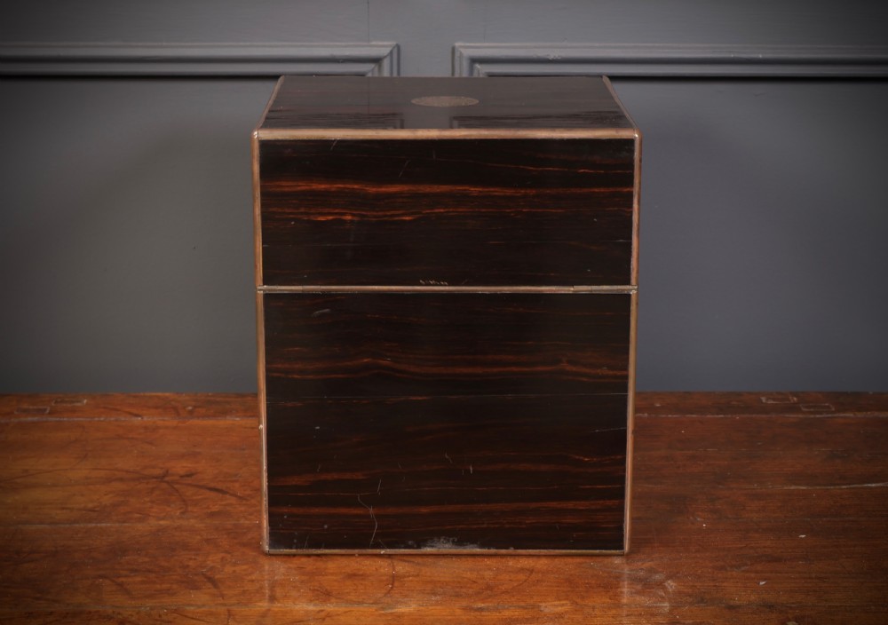 A Victorian coromandel wood decanter box lined with purple velvet, containing four square cut-glass decanters with faceted square stoppers. View X