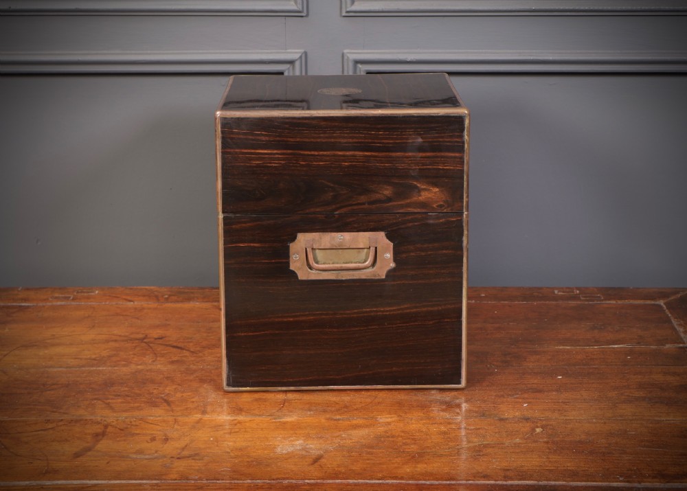 A Victorian coromandel wood decanter box lined with purple velvet, containing four square cut-glass decanters with faceted square stoppers. View XI