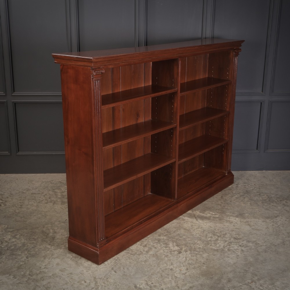 A large Victorian open oak bookcase featuring two wide bays with adjustable shelves, fluted pilasters, and a solid plinth base. View II