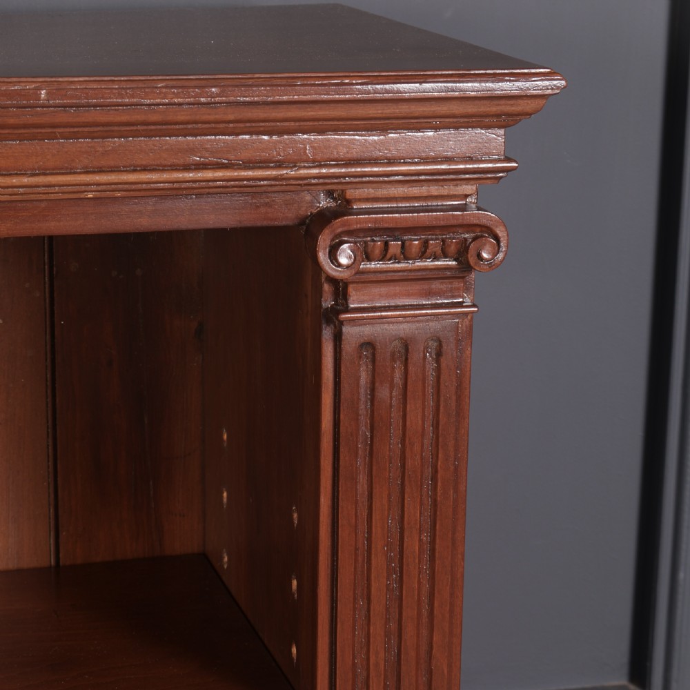 A large Victorian open oak bookcase featuring two wide bays with adjustable shelves, fluted pilasters, and a solid plinth base. View III
