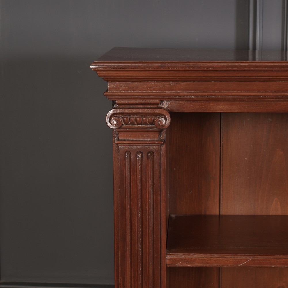 A large Victorian open oak bookcase featuring two wide bays with adjustable shelves, fluted pilasters, and a solid plinth base. View VII