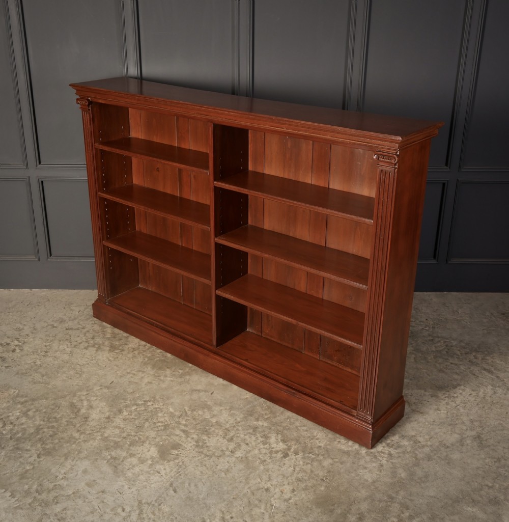 A large Victorian open oak bookcase featuring two wide bays with adjustable shelves, fluted pilasters, and a solid plinth base. View VIII