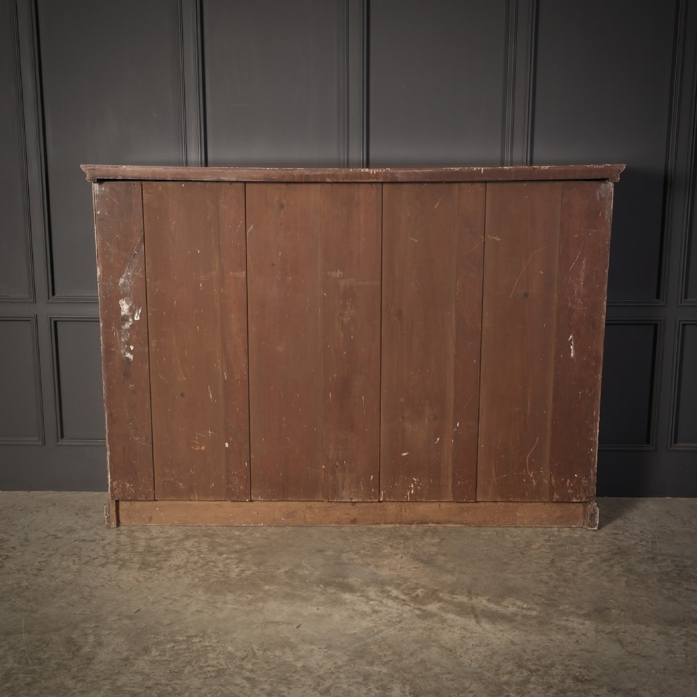 A large Victorian open oak bookcase featuring two wide bays with adjustable shelves, fluted pilasters, and a solid plinth base. View X