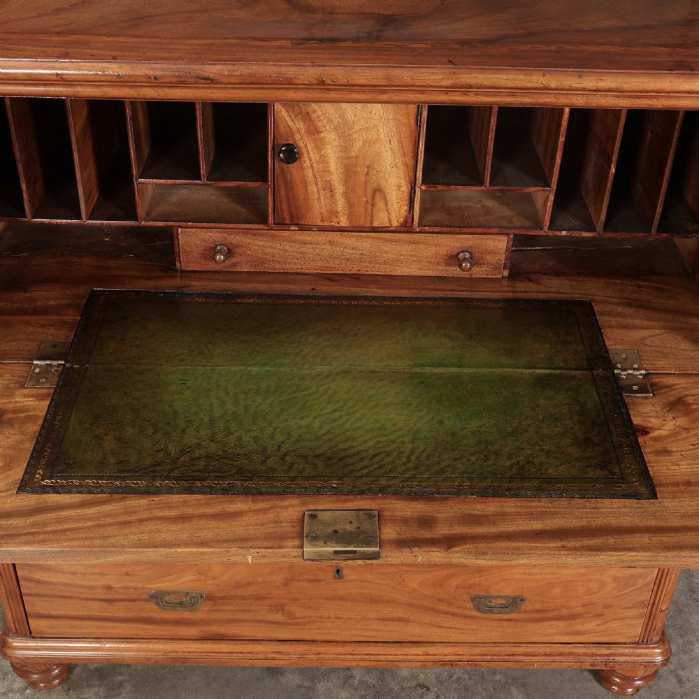 A Victorian camphor wood military campaign secretaire chest featuring brass flush recessed handles and turned feet. View VI