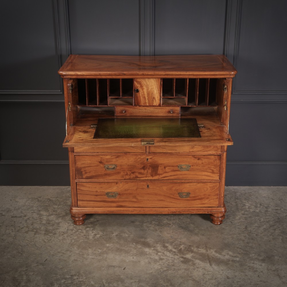 A Victorian camphor wood military campaign secretaire chest featuring brass flush recessed handles and turned feet. View VII