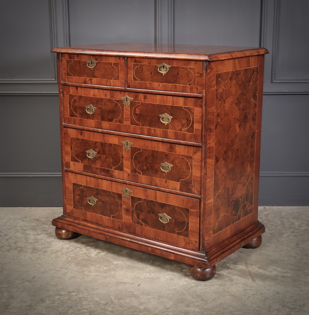 A William and Mary period chest of drawers with decorative oyster veneering, stringing inlay, brass teardrop handles, and turned bun feet. View XI