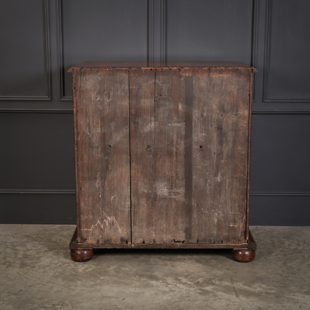 A William and Mary period chest of drawers with decorative oyster veneering, stringing inlay, brass teardrop handles, and turned bun feet. View XIV