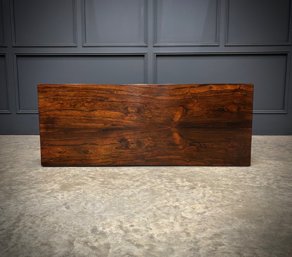 A William IV rosewood side cabinet with twin arch-topped mirrored doors, carved foliage details along the frieze, and a sturdy plinth base. View XII