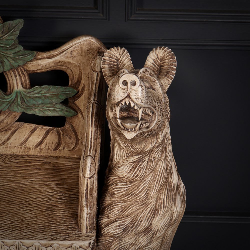 A carved light brown wooden two-seat bench featuring full-standing bear supports on each side and a central carved bear with green painted leaves on the backrest. View VII