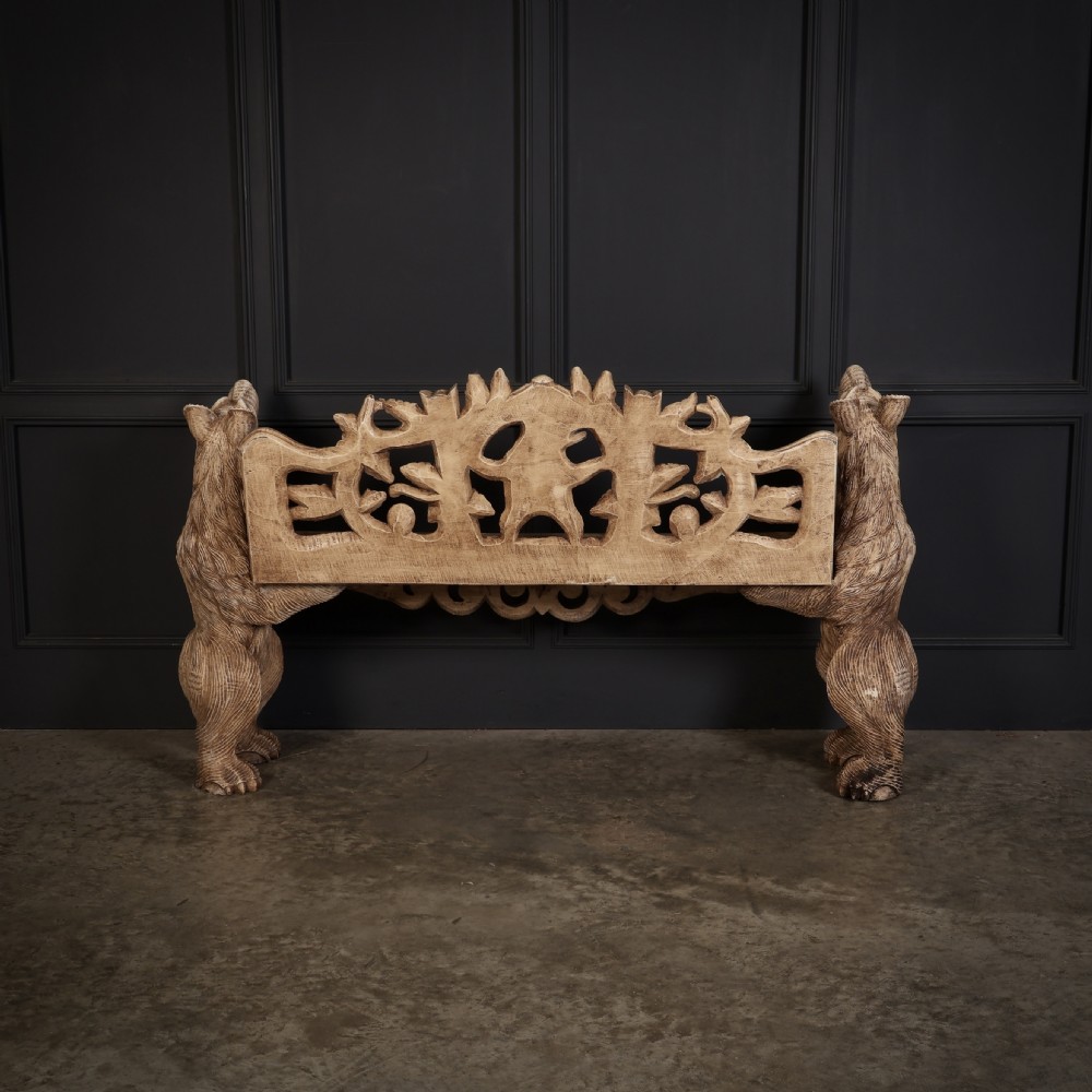 A carved light brown wooden two-seat bench featuring full-standing bear supports on each side and a central carved bear with green painted leaves on the backrest. View XI