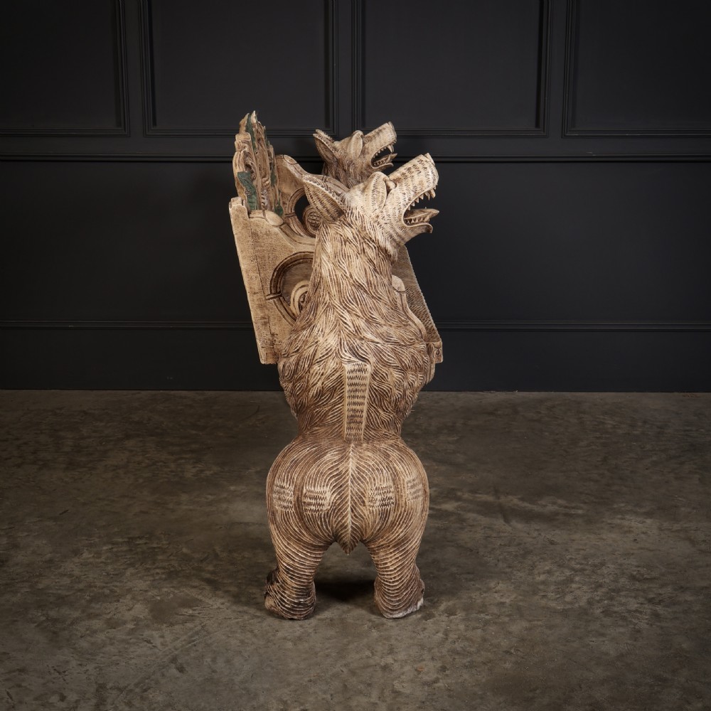 A carved light brown wooden two-seat bench featuring full-standing bear supports on each side and a central carved bear with green painted leaves on the backrest. View XII