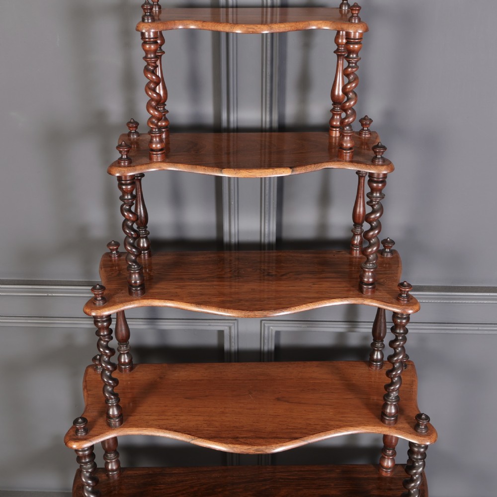 A Victorian rosewood six-tier whatnot stand featuring graduated open shelves supported by barley twist columns and topped with turned finials. View II