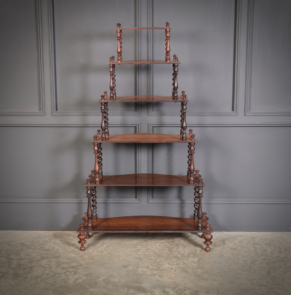 A Victorian rosewood six-tier whatnot stand featuring graduated open shelves supported by barley twist columns and topped with turned finials. View XII