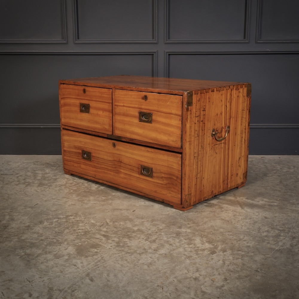 A low camphor wood campaign chest featuring recessed brass handles, brass corner brackets, exposed dovetail joints, and side brass carrying handles. View VI