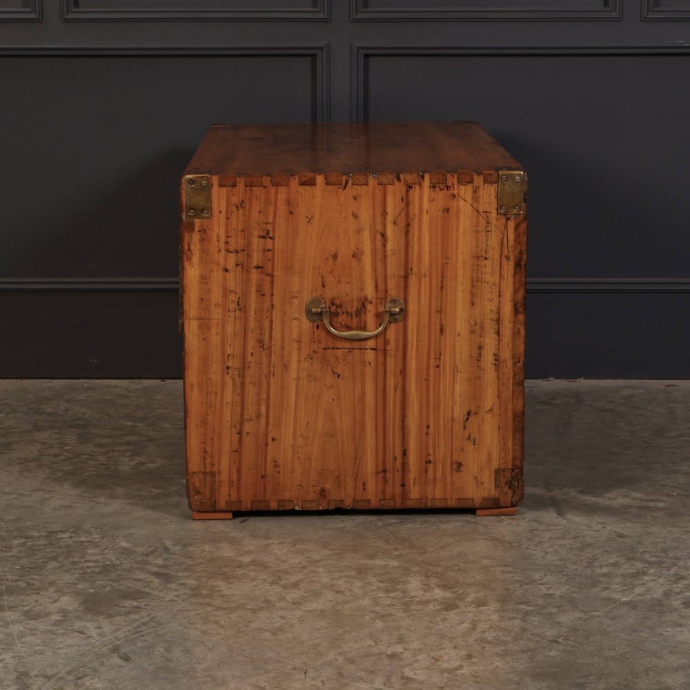 A low camphor wood campaign chest featuring recessed brass handles, brass corner brackets, exposed dovetail joints, and side brass carrying handles. View IX