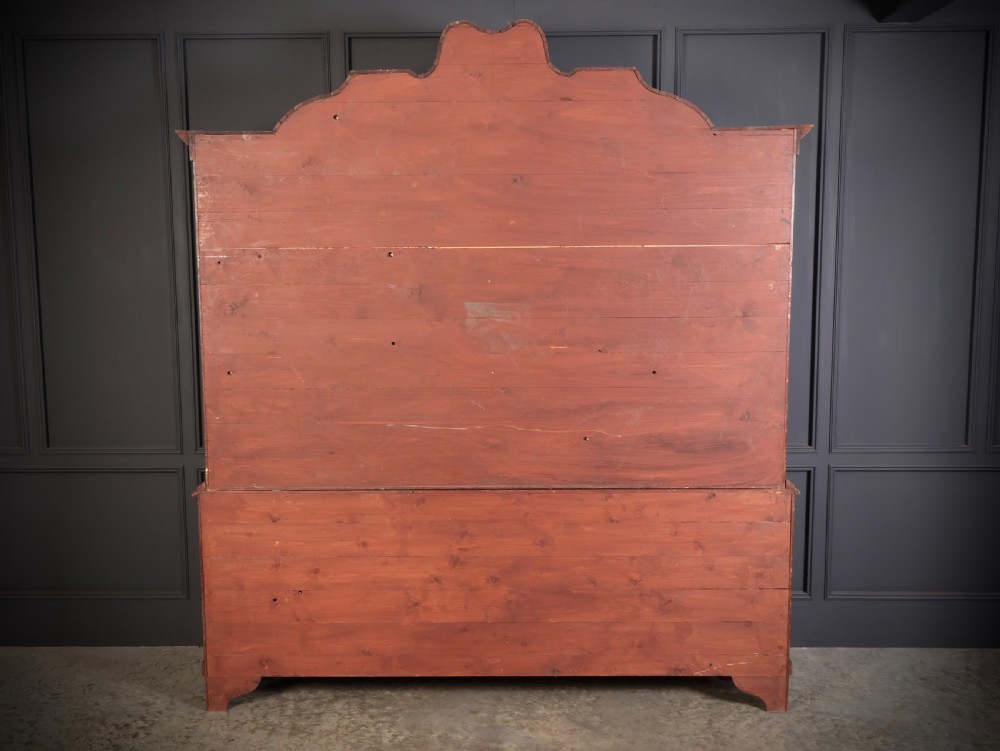 A Dutch Baroque style walnut display cabinet featuring floral marquetry, a glazed double-door upper section, and a three-drawer bombe base. View IX