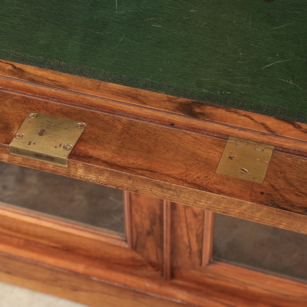 A two-part William IV walnut bookcase featuring upper and lower glazed doors with carved corbel accents and a plinth base. View VIII