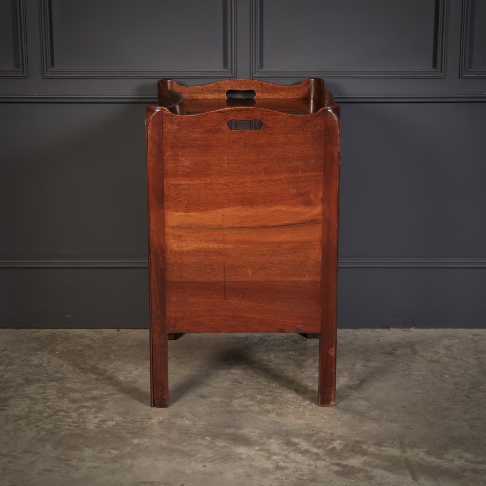 A George III mahogany nightstand featuring a gallery top, concave front with a tambour door, and a single lower drawer with oval inlay. View VII