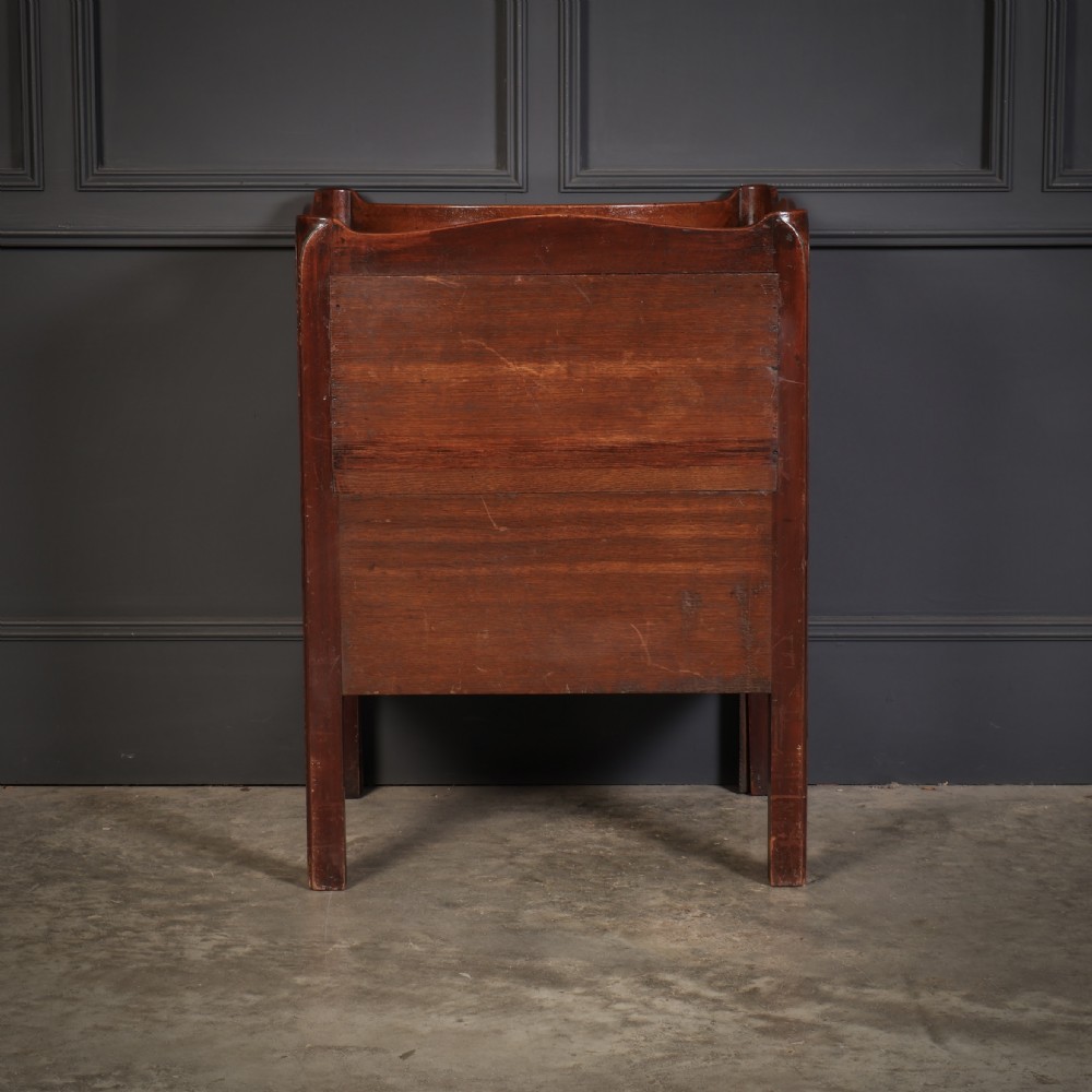 A George III mahogany nightstand featuring a gallery top, concave front with a tambour door, and a single lower drawer with oval inlay. View VIII