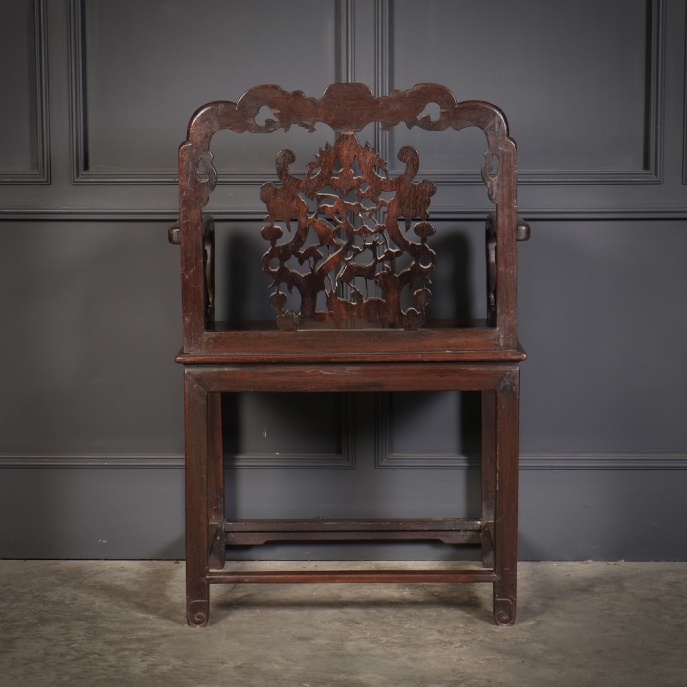 A pair of traditional Chinese dark hardwood Hongmu armchairs with intricately carved openwork back panels and rectangular seats. View XI