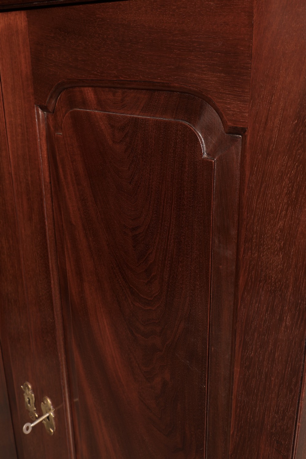 A George III mahogany estate cabinet shown with open panelled doors, revealing an interior with shelves on one side and multiple fitted drawers with brass ring handles on the other. View VIII