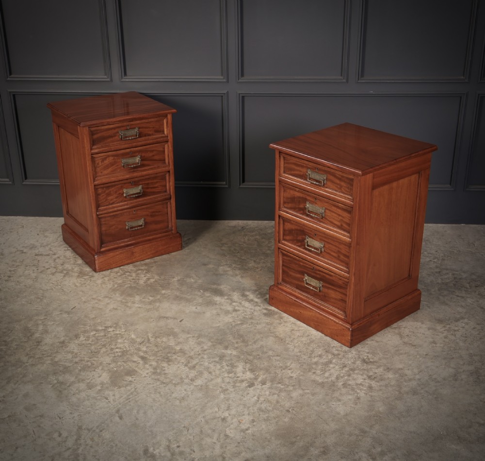 A pair of Victorian mahogany bedside chests with four graduated drawers each, brass index pull handles, and plinth bases. View II