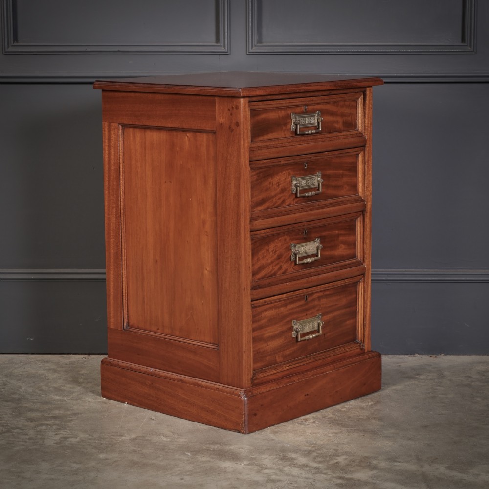 A pair of Victorian mahogany bedside chests with four graduated drawers each, brass index pull handles, and plinth bases. View VI