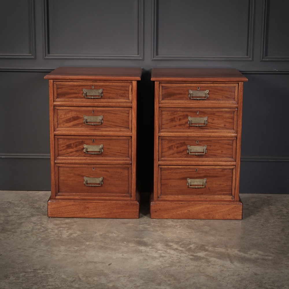 A pair of Victorian mahogany bedside chests with four graduated drawers each, brass index pull handles, and plinth bases. View VII