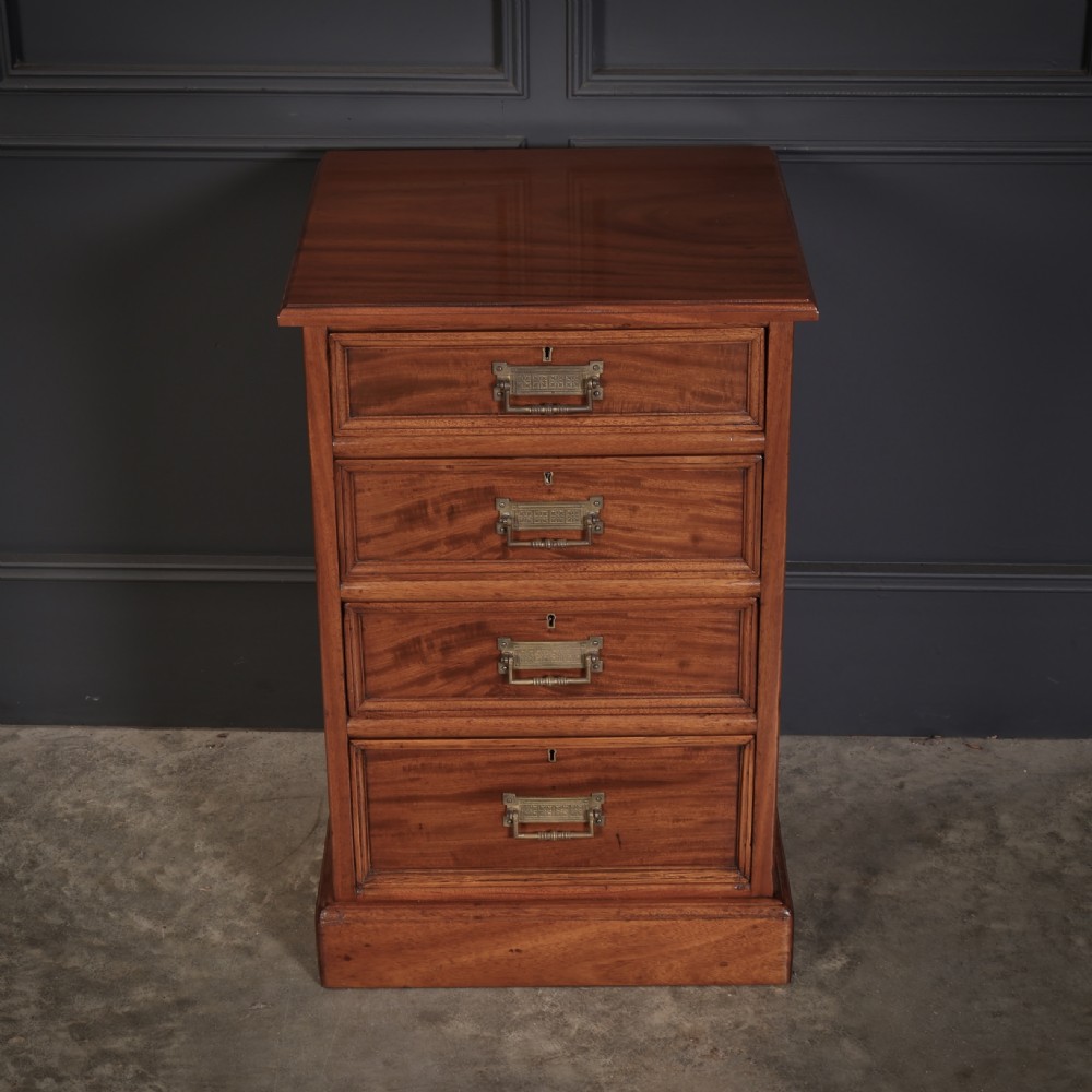 A pair of Victorian mahogany bedside chests with four graduated drawers each, brass index pull handles, and plinth bases. View VIII