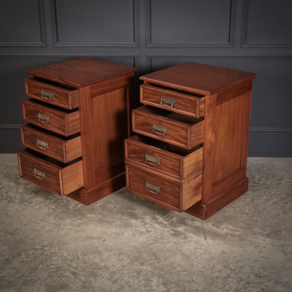 A pair of Victorian mahogany bedside chests with four graduated drawers each, brass index pull handles, and plinth bases. View XI