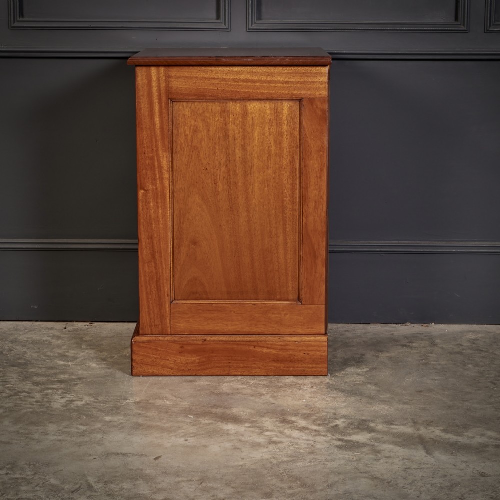 A pair of Victorian mahogany bedside chests with four graduated drawers each, brass index pull handles, and plinth bases. View XII