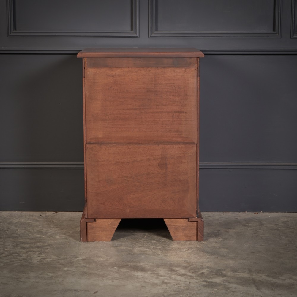 A pair of Victorian mahogany bedside chests with four graduated drawers each, brass index pull handles, and plinth bases. View XIII