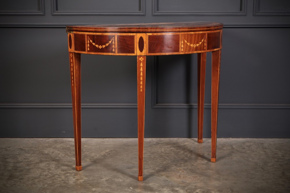 An 18th-century demilune tea table made of dark mahogany with satinwood marquetry inlays featuring a fan motif and tapered legs. View III