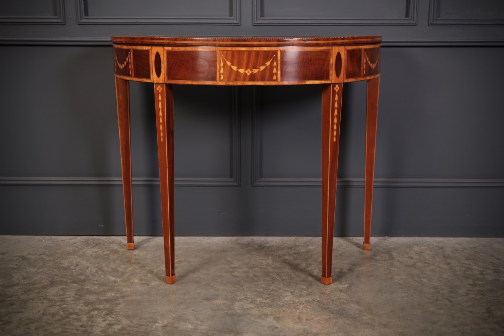 An 18th-century demilune tea table made of dark mahogany with satinwood marquetry inlays featuring a fan motif and tapered legs. View VII