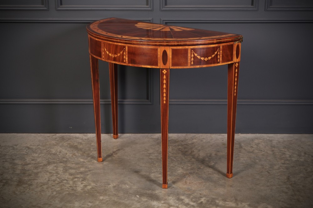 An 18th-century demilune tea table made of dark mahogany with satinwood marquetry inlays featuring a fan motif and tapered legs. View VIII