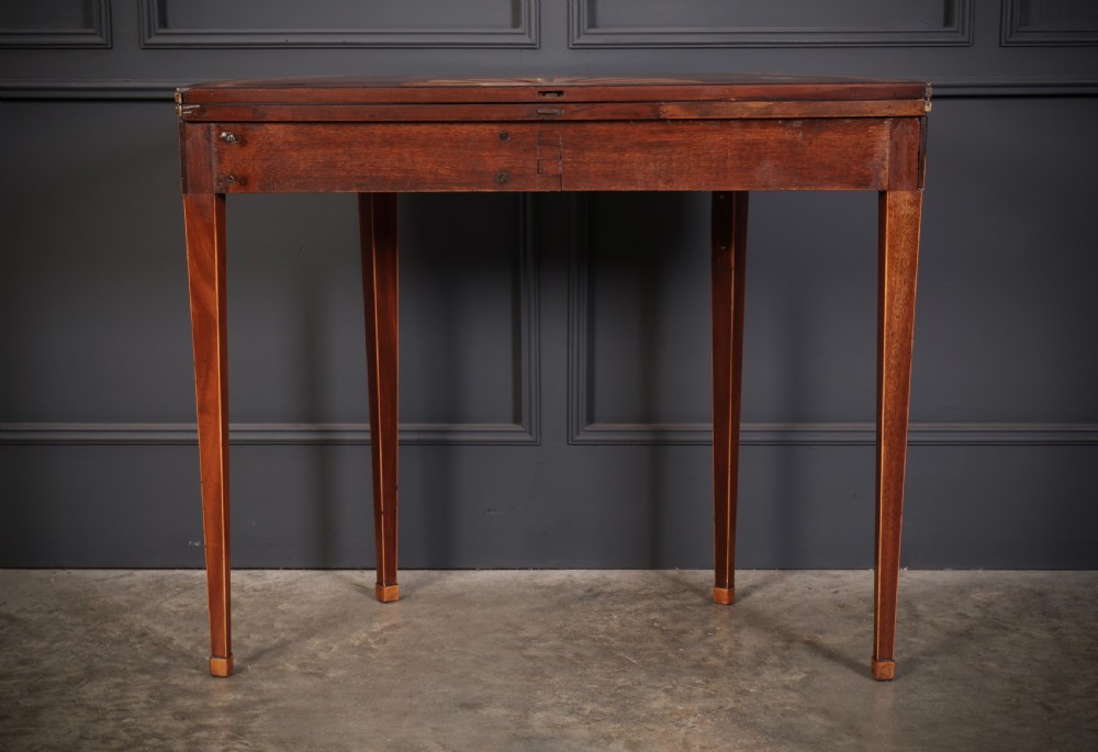 An 18th-century demilune tea table made of dark mahogany with satinwood marquetry inlays featuring a fan motif and tapered legs. View XI