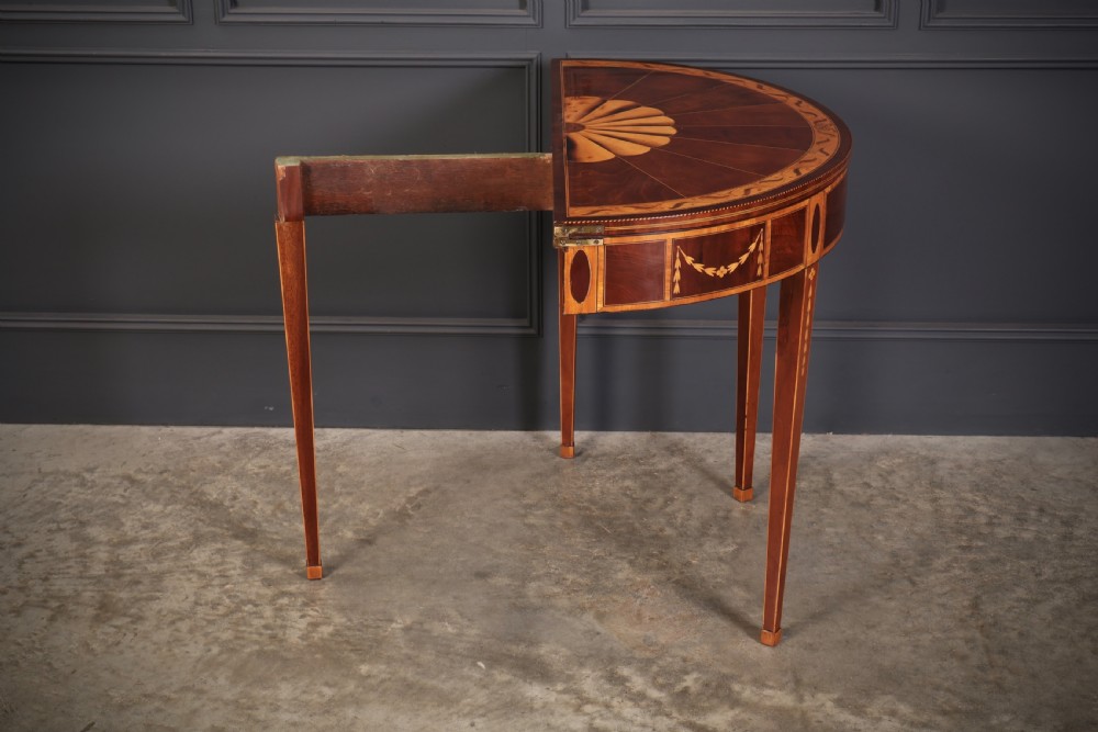An 18th-century demilune tea table made of dark mahogany with satinwood marquetry inlays featuring a fan motif and tapered legs. View XIII