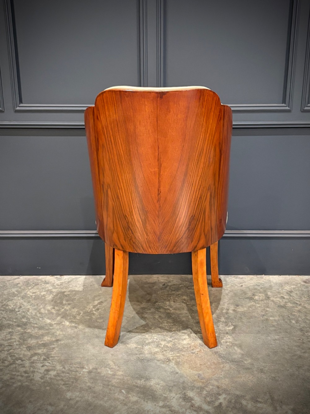 A pair of Art Deco armchairs featuring curved walnut veneer frames and cream leather upholstery. View XI